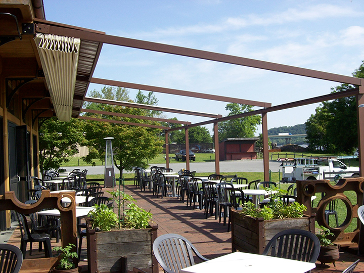 Retractable Pergolas in Columbia MD pergola awning that is open and seating area is empty